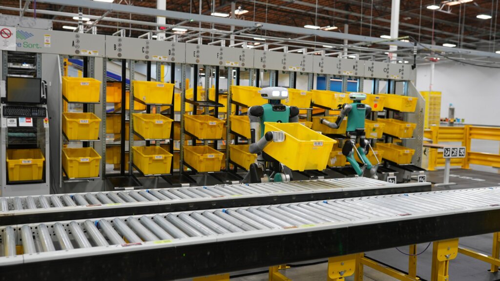 Humanoid moving boxes in Amazon factory