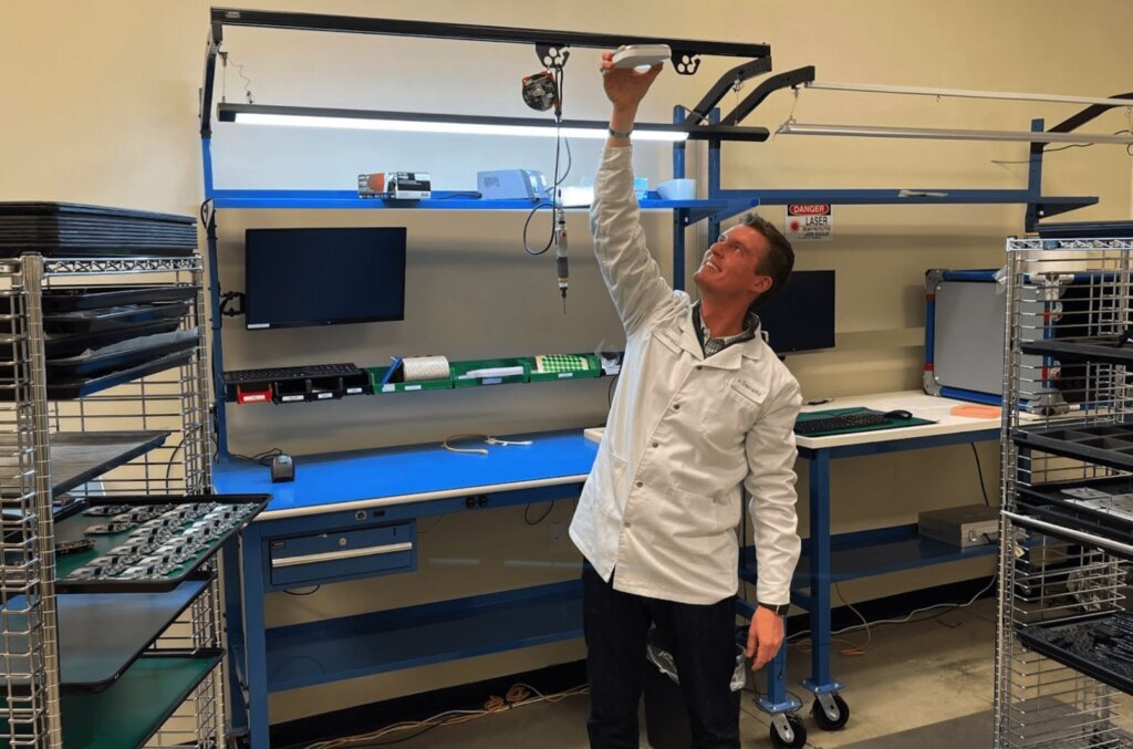 Garrett Bastable, Head of Operations at Density, holds a Density people counting device in his factory in Syracuse, NY