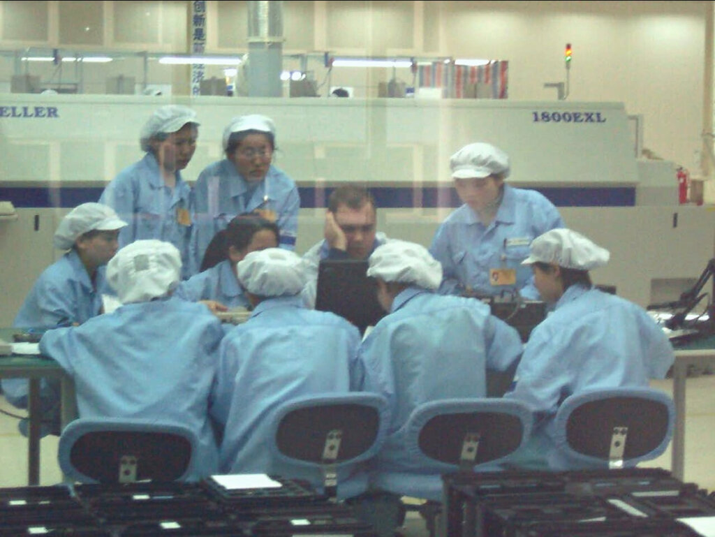 Sam Bowen sitting with an engineering team in China
