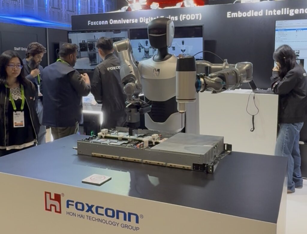 Foxconn's wheeled-base humanoid fastening screws on a AI server at GTC 2026